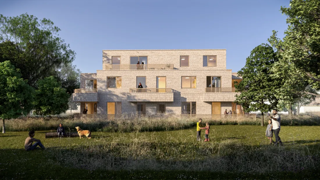 Gevelbeeld appartementen aan de parktuin bij avondlicht
